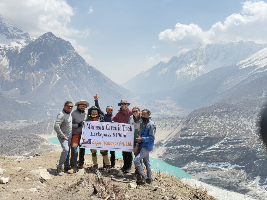 trekkers holding banner of Nepal Trekscape on the way of Manaslu Base Camp