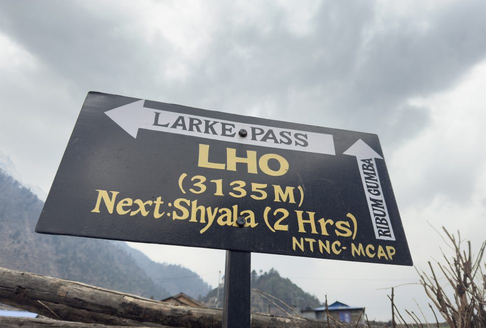 Signboard showing Lho Village at an elevation of 3135 meters on the Manaslu Circuit Trek route