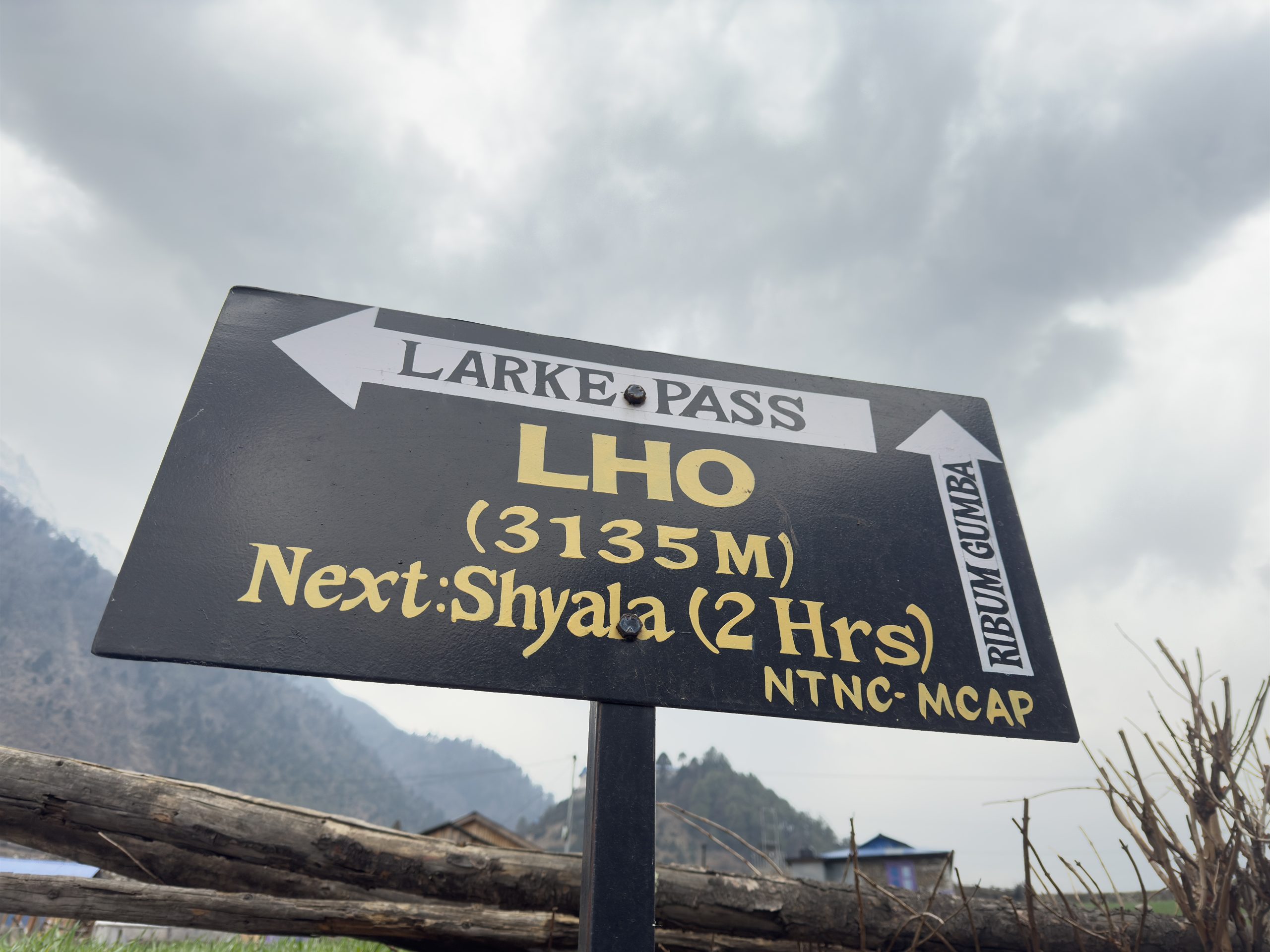 Signboard showing Lho Village at an elevation of 3135 meters on the Manaslu Circuit Trek route
