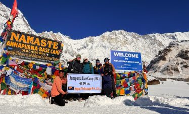 Trekkers with lead guide and owner of Nepal Trekscape Ajit Adhikari at Annapurna Base Camp during the Annapurna Base Camp Trek in Nepal